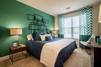 a bedroom with green walls and a large bed